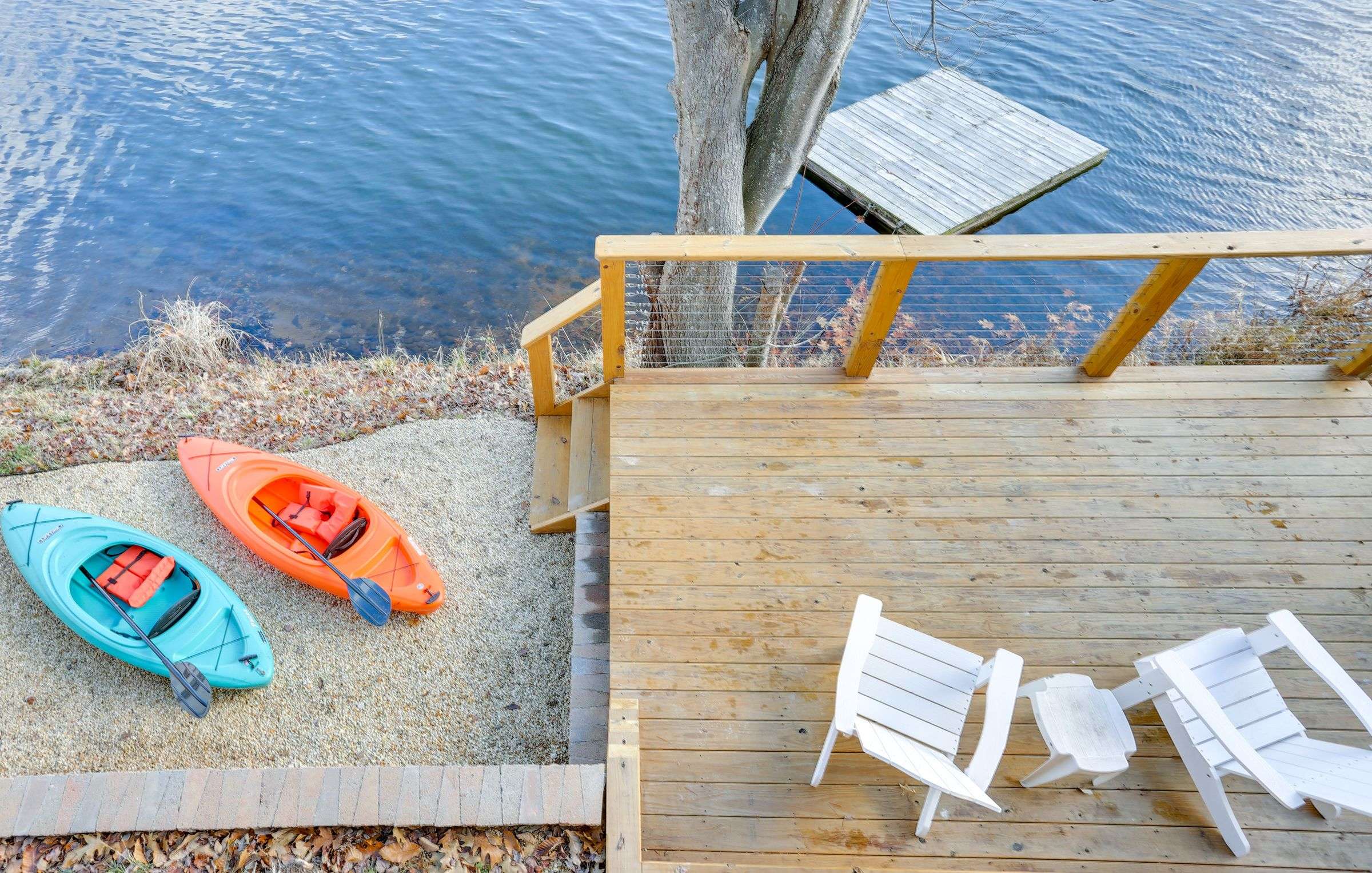 Looking down on the kayaks, deck steps and the swim dock floating just off the shoreline.